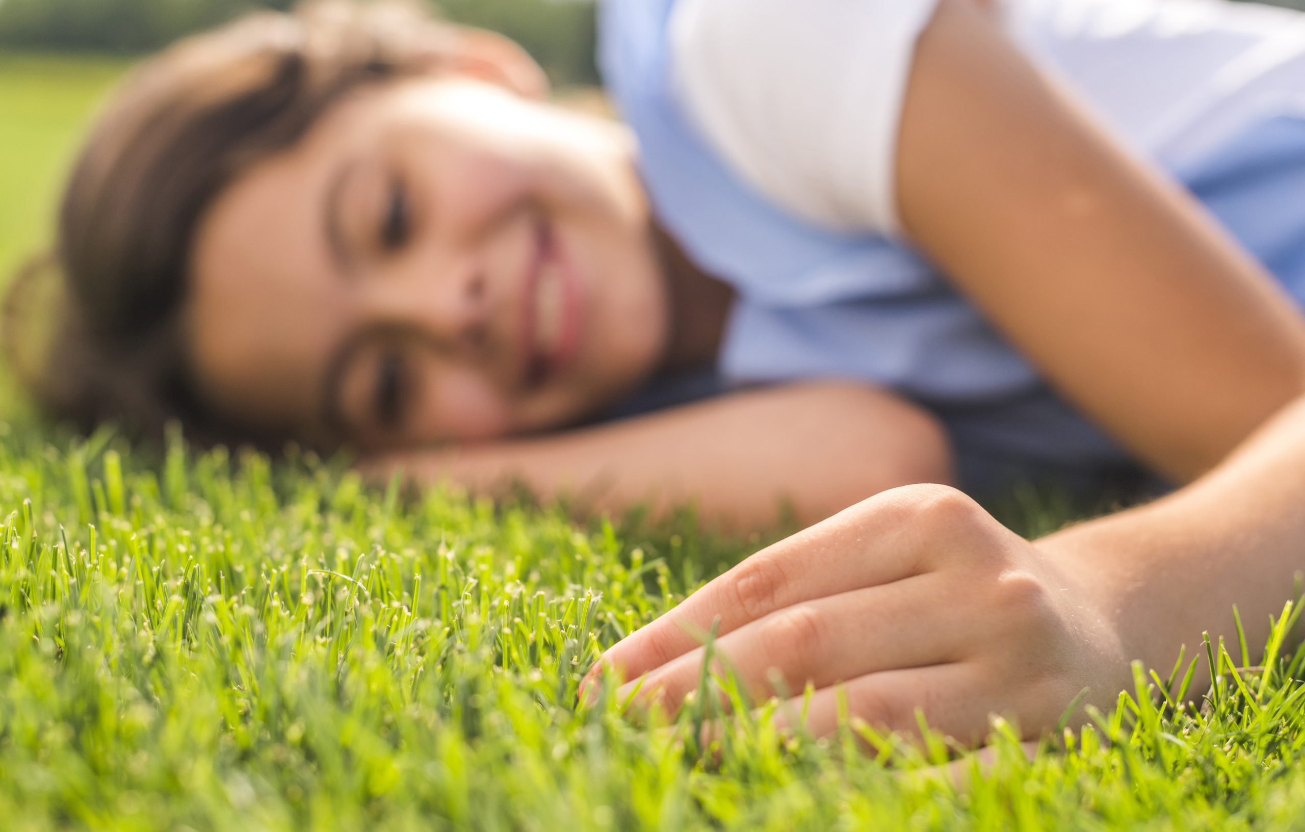 little-girl-touching-grass